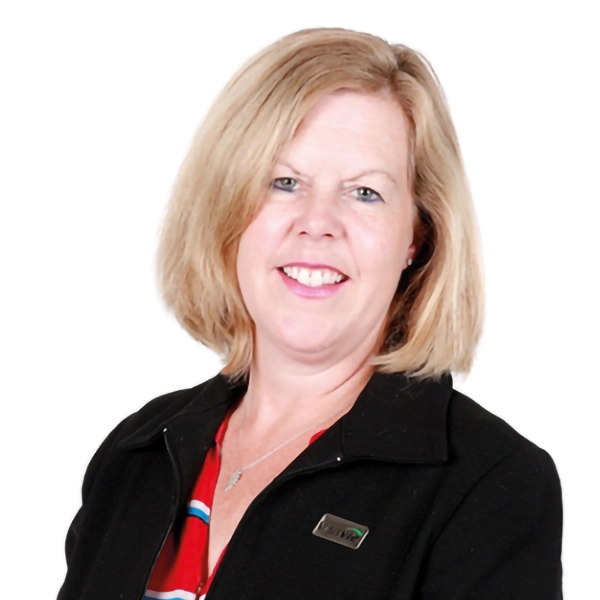 Compassionate senior care professional smiling, promoting trust and quality assisted living services.